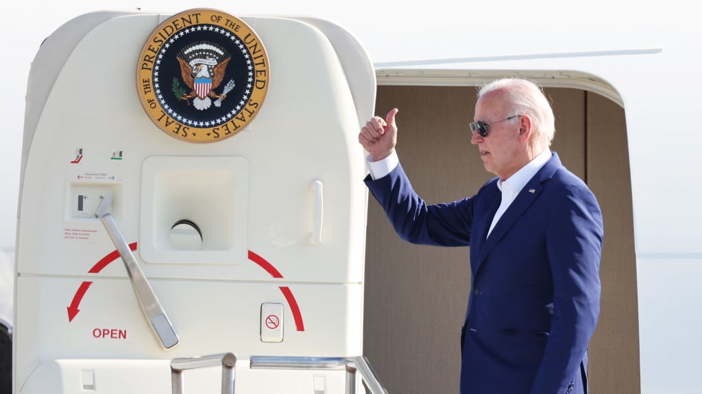 U.S. President Joe Biden gives members of his staff a thumbs up as he boards Air Force One.