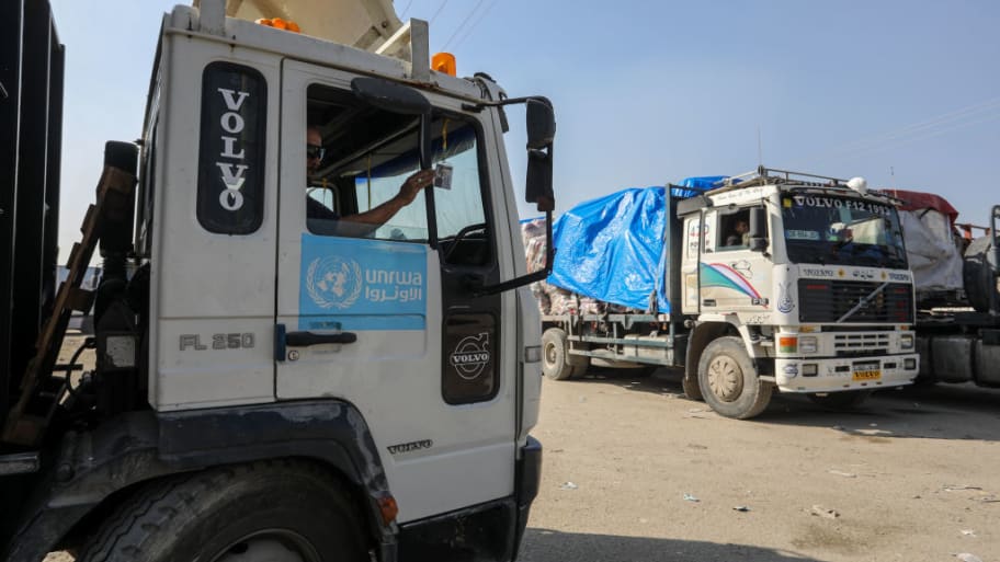 UNRWA trucks pass through the Rafah border crossing into Gaza.