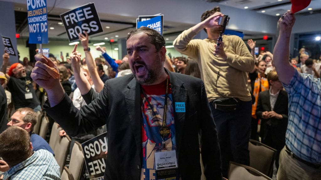 A Libertarian party member shouts protests as former US President and Republican presidential candidate Donald Trump addresses the Libertarian National Convention in Washington, DC, May 25, 2024.