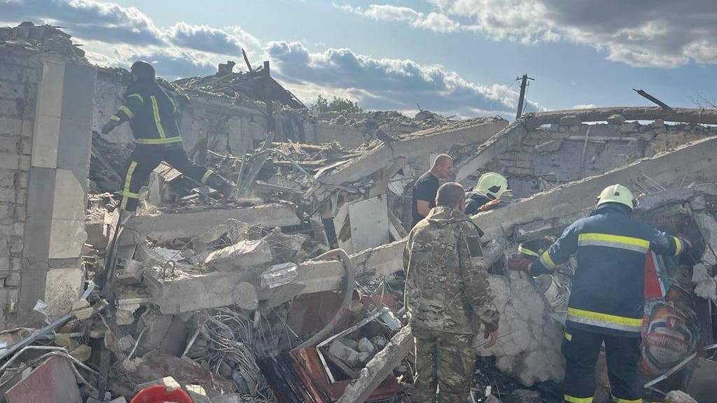 Rescuers work at a site of a Russian military strike, amid Russia's attack on Ukraine, in the village of Hroza, in Kharkiv region,