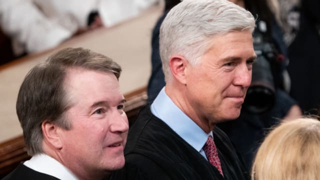 Brett Kavanaugh and Neil Gorsuch stare forward while at the State of the Union.