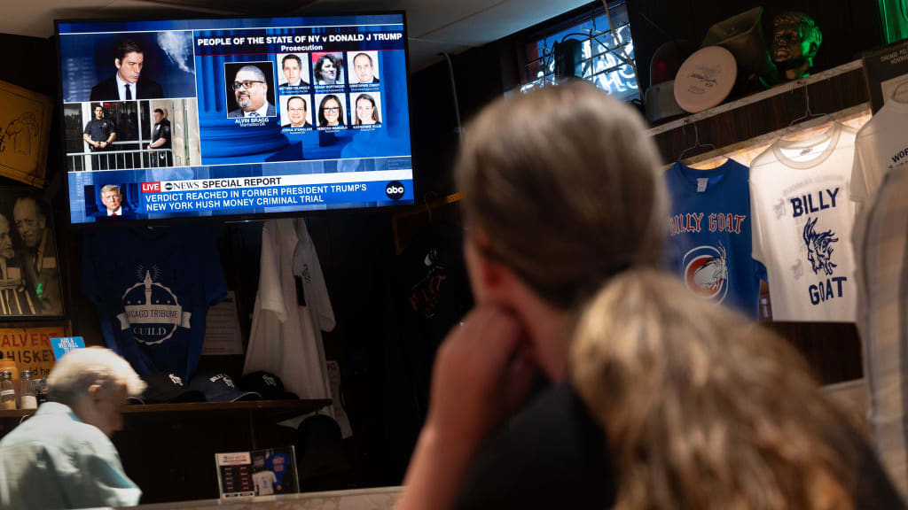 The trial of Republican presidential candidate former President Donald Trump is broadcast on the television at the Billy Goat Tavern in Chicago.