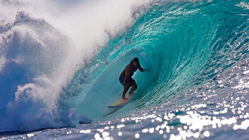 Tamayo Perry surfs a barrel in Hawaii.