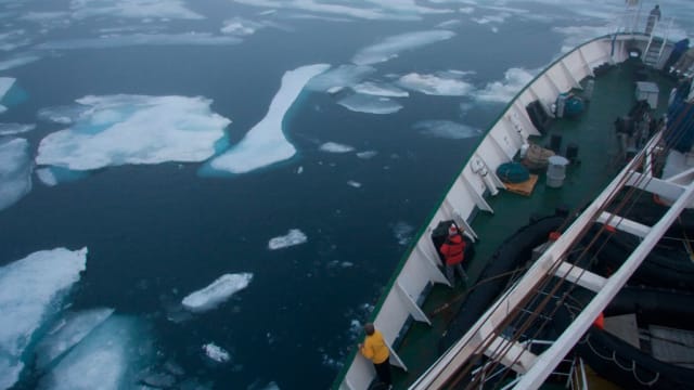 A ship cuts through ice in Arctic Canada.