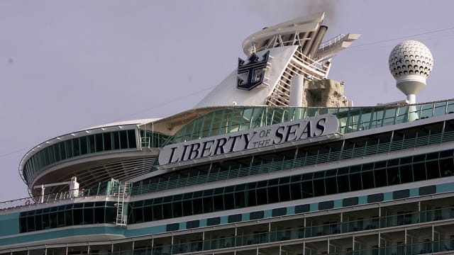 Smoke billows out of the top of the Liberty of the Seas cruise liner by Royal Caribbean.
