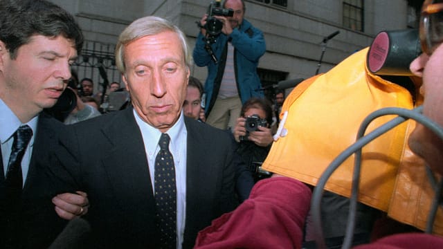 Ivan Boesky is photographed while being escorted out of a courthouse.