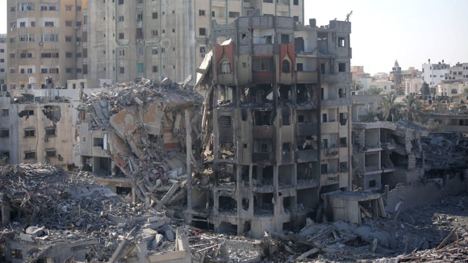 Palestinian citizens inspect damage to their homes caused by Israeli airstrikes on Oct. 13, 2023, in Gaza City, Gaza.