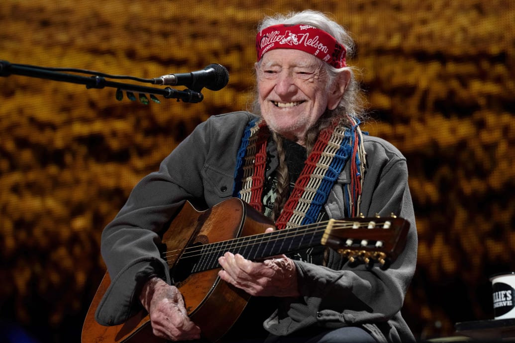 Photo of Willie Nelson performing