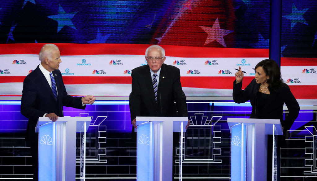 Then-Sen. Kamala Harris and Joe Biden speak as Sen. Bernie Sanders looks on during a 2019 Democratic presidential primary debate.