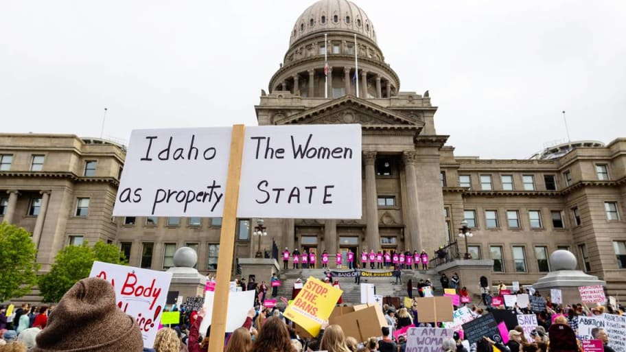An attendee at an abortion rights rally holds a sign outside the Idaho Capitol.