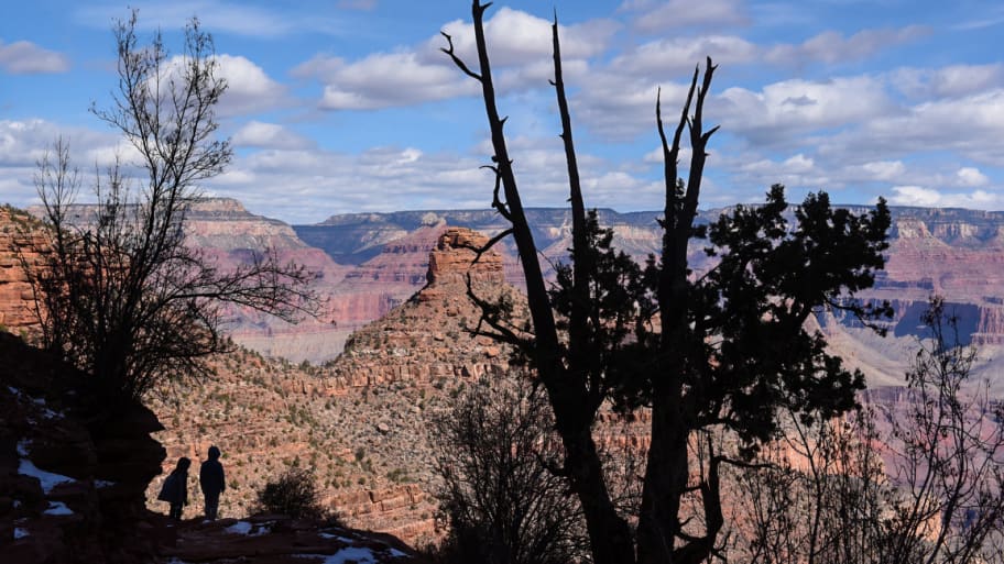 People hike on the Bright Angel Trail in the Grand Canyon near Grand Canyon Village.