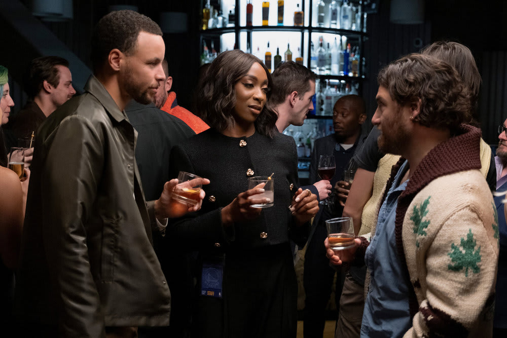 A photo still of Stephen Curry, Ego Nwodim, and Adam Pally