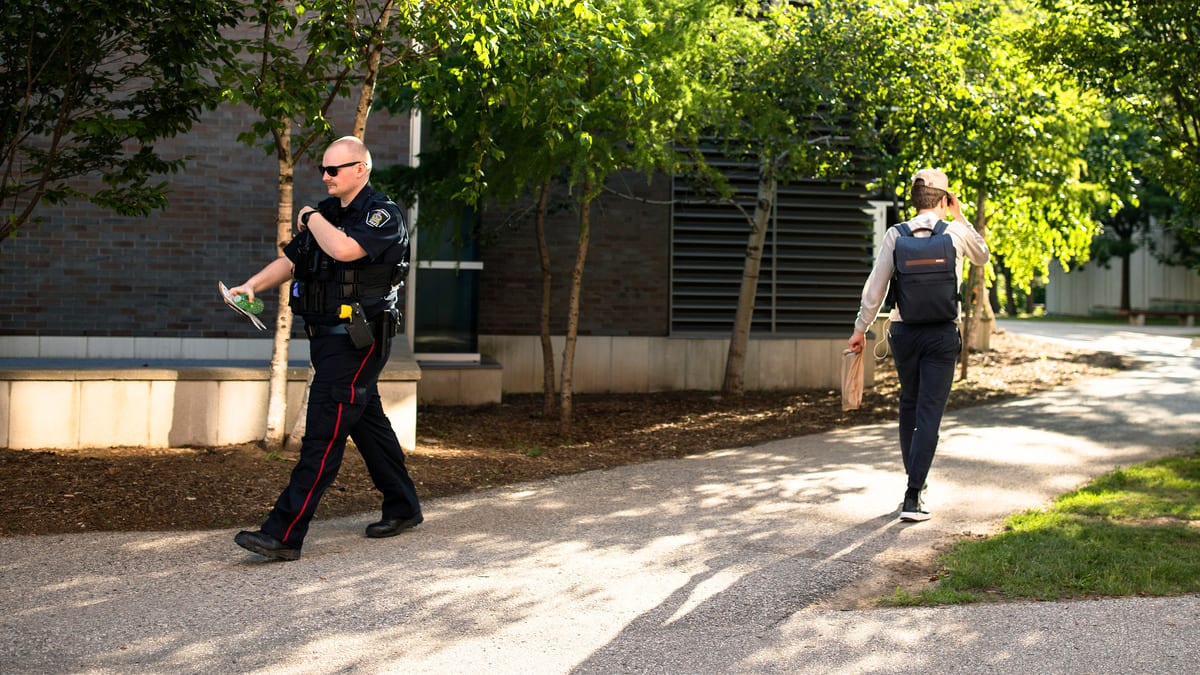 A member of the Waterloo Regional Police walks on campus following a stabbing at the University of Waterloo, in Waterloo, Ontario.
