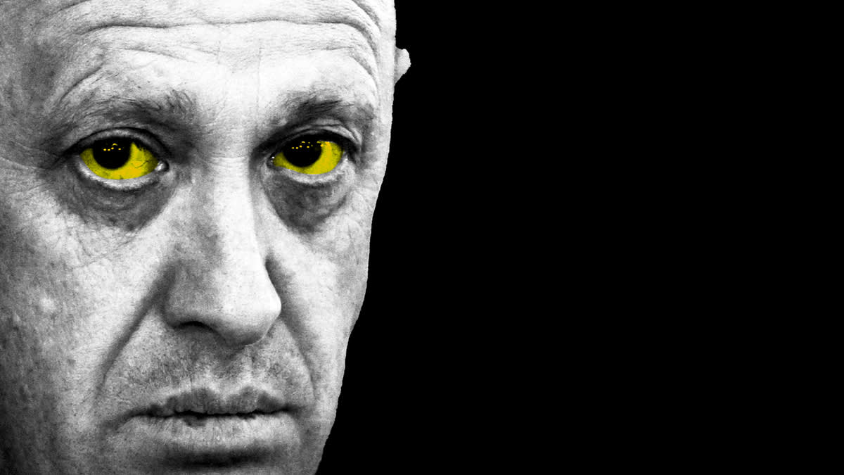 Head of the Wagner Group, Yevgeny Prigozhin, on a black background with yellow eyes.