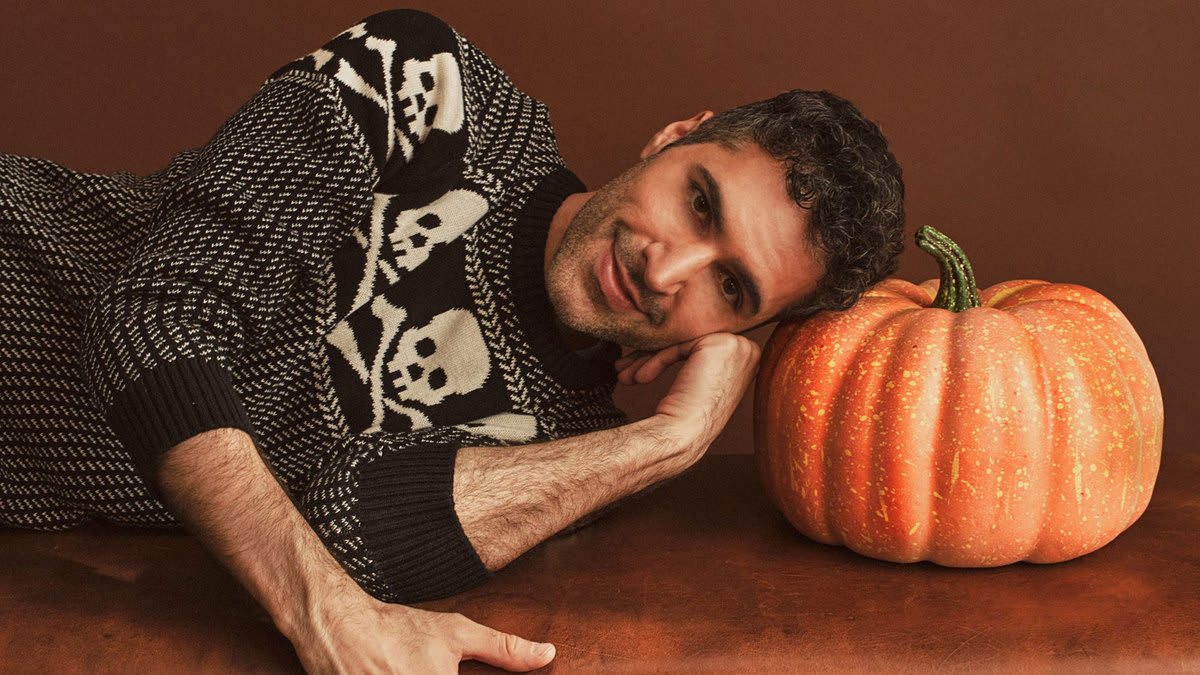 Danny Pellegrino laying with his head on a pumpking