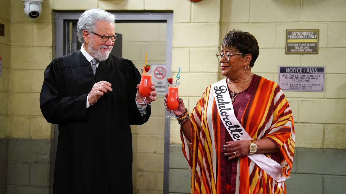 John Larroquette stands in a judge robe and cheers Marsha Warfield in a still from ‘Night Court’