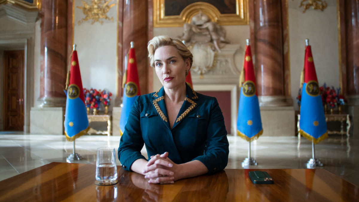 Kate Winslet sitting behind a desk in a still from ‘The Regime’