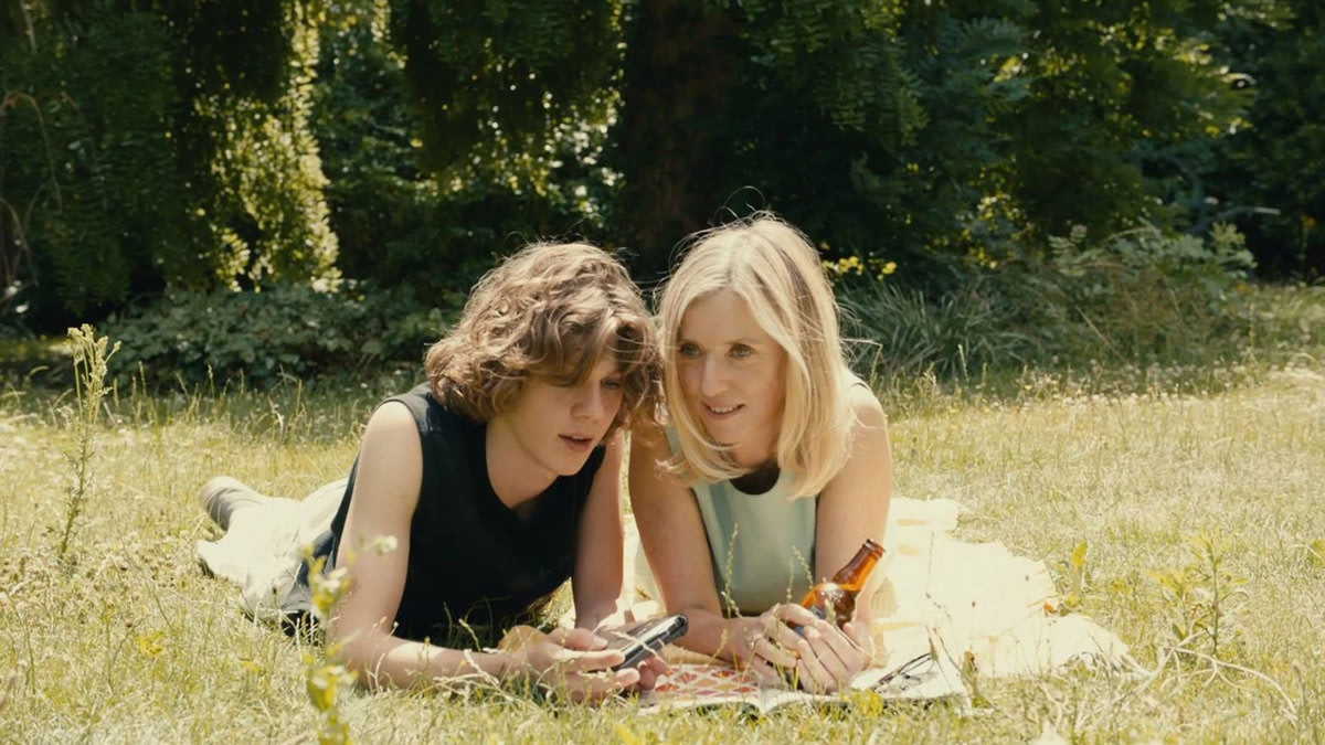 Lea Drucker and Samuel Kircher lay in a field in a still from ‘Last Summer’