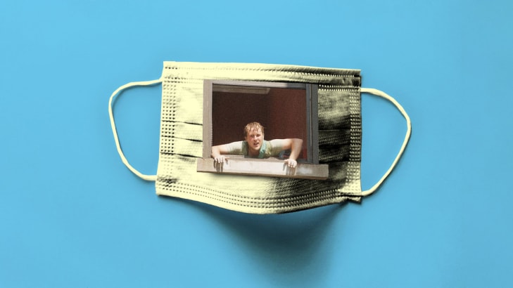 A photo illustration of John Early looking out of a window in a COVID mask