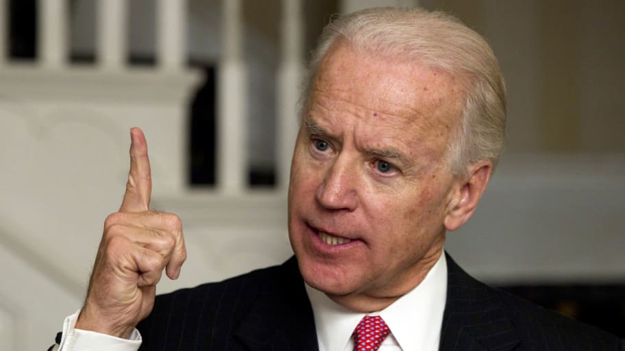 President Joe Biden is seen pointing upward.