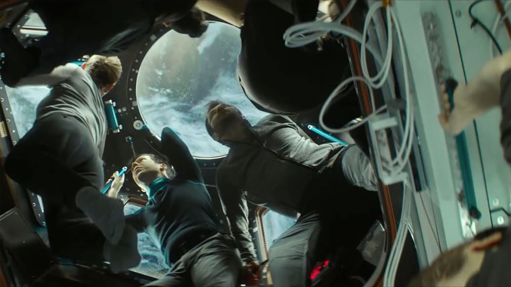 A still from I.S.S. of astronauts floating around inside a ship