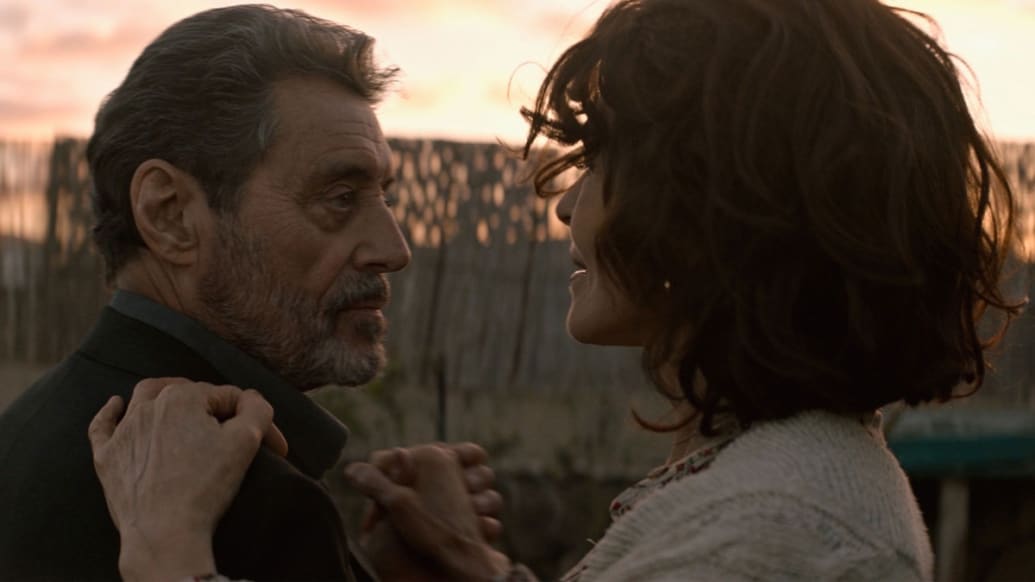 Ian McShane and Fanny Ardant hold each other close while they dance in a still from ‘American Star’