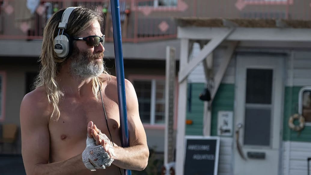 Chris Pine holds a pool skimmer in a still from ‘Poolman’