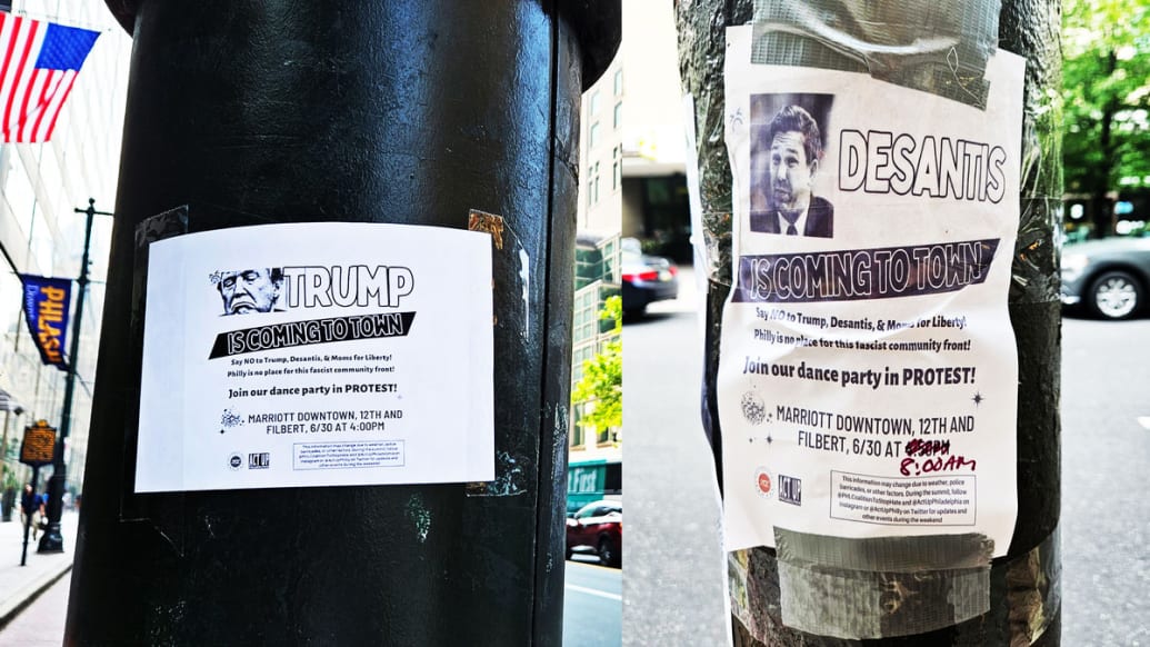 A photo that includes a street view of Donald Trump and Ron DeSantis Protest Posters in Philadelphia.