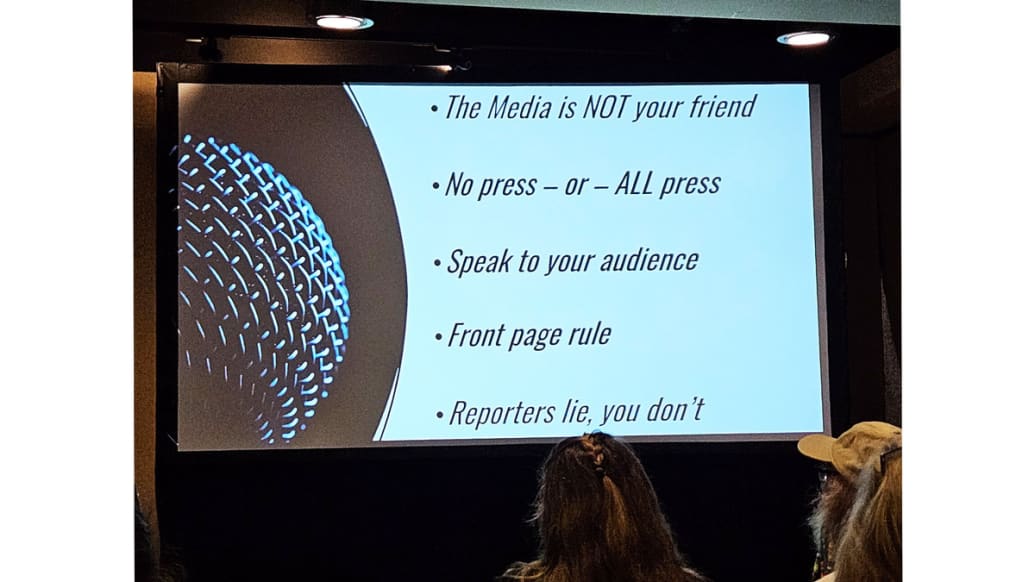 A photo that includes a presentation slide on handling the media from the Moms for Liberty Conference.