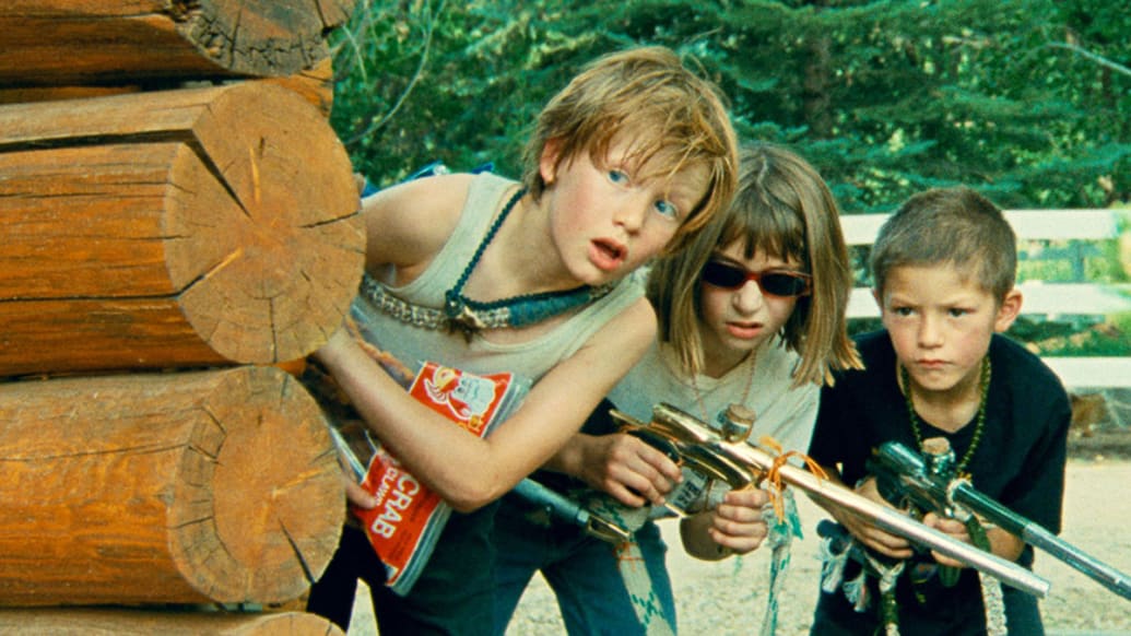 Photo still of three children with guns in 'Riddle of Fire'