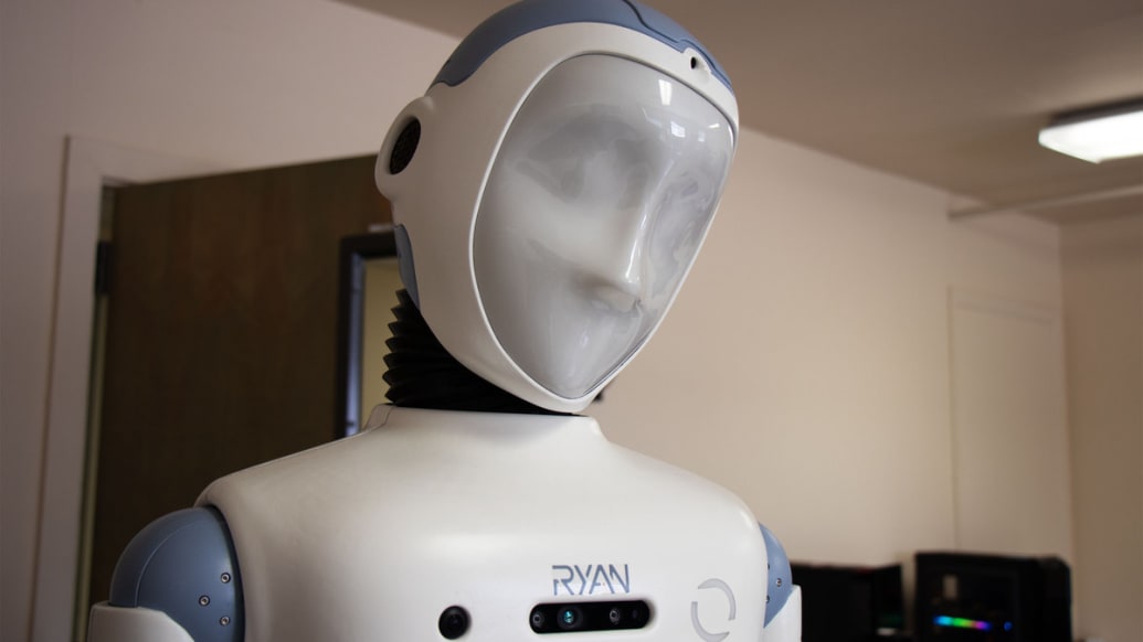 RYAN the social robot sits on a table with his face turned off. 