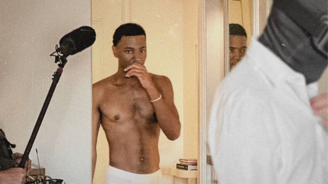 Jerrod Carmichael walks into a hotel shirtless in a still from ‘Jerrod Carmichael Reality Show’