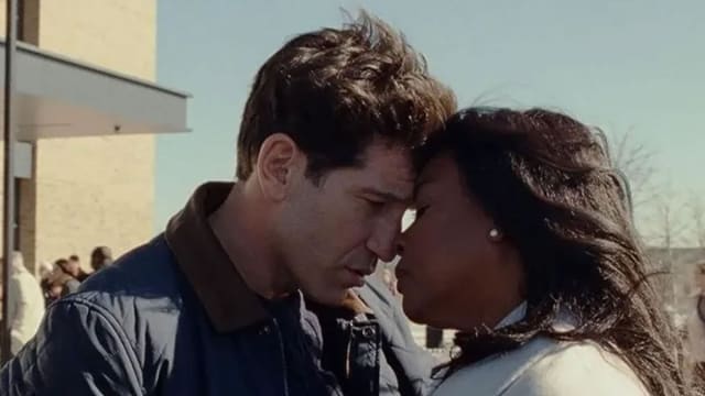 A still from ‘Origins' shows Aunjanue Ellis-Taylor and Jon Bernthal head to head in an embrace.