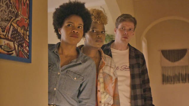 A photo from the show 'The Other Black Girl' Sinclair Daniels, Brittany Abedumola, and Hunter Parrish looking around a corner