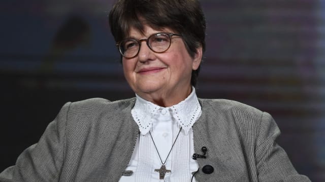 Sister Helen Prejean sitting on a stage.