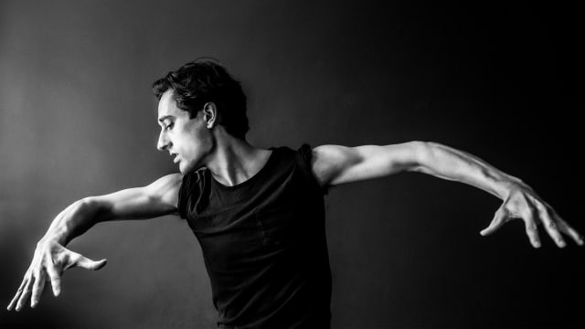 A black and white portrait of Justin Peck.