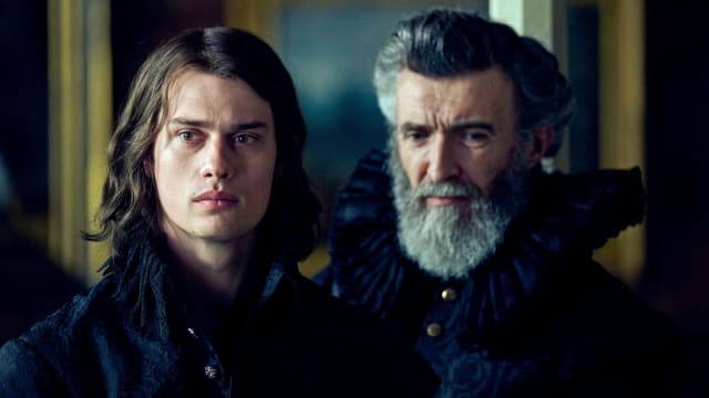 Nicholas Galitzine and Mark O’Halloran stand next to each other in a still from ‘George and Mary’