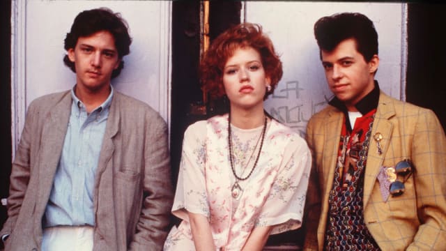A photo still of Andrew McCarthy, Molly Ringwald, and Jon Cryer