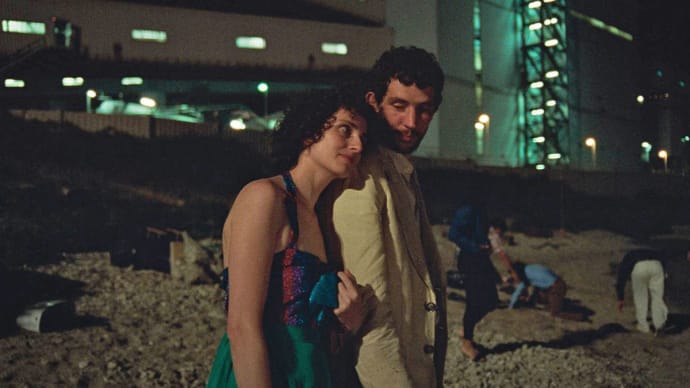Josh O’Connor and Carol Duarte walk arm in arm in a still from ‘La Chimera’