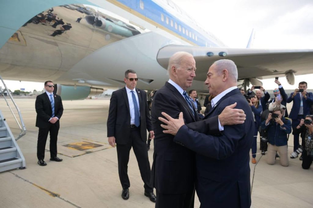 President Joe Biden is greeted by Israeli Prime Minister Benjamin Netanyahu on a tarmac in Tel Aviv.
