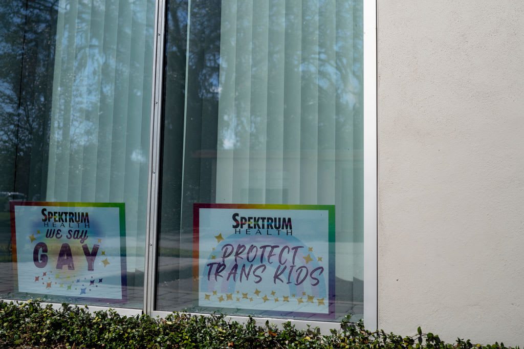 Signs displayed in windows at Spectrum Health in Orlando, Florida.