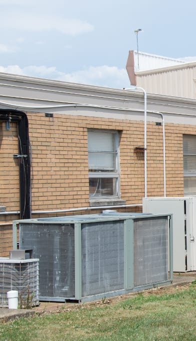 AC unit next to a brick building