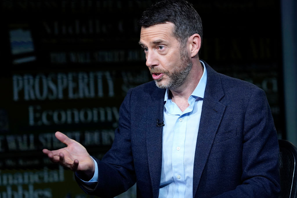 David Plouffe speaks on stage at an event.