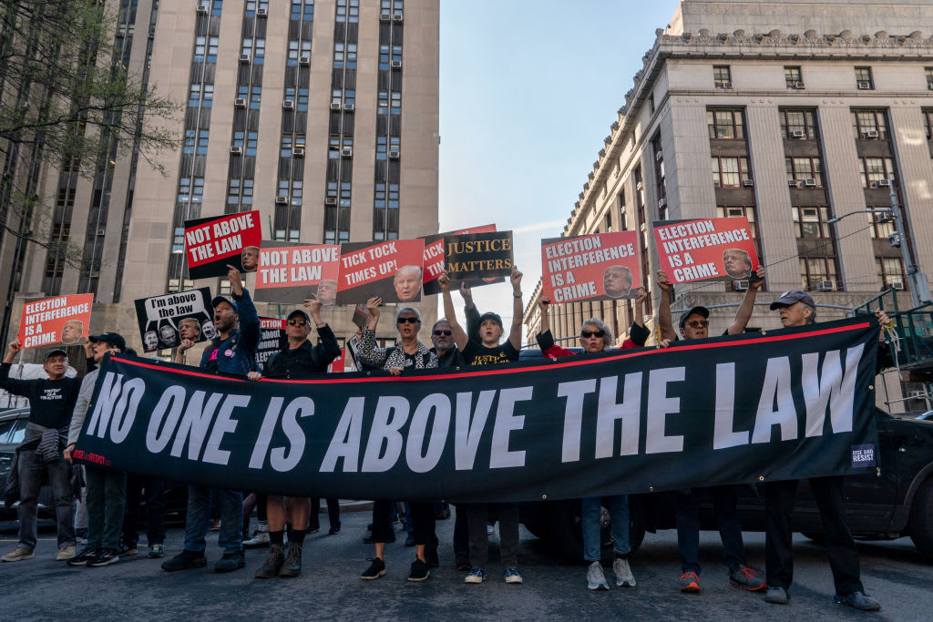 Demonstrators protest outside of Manhattan Criminal Court as former US President Donald Trump attends the first day of his trial for allegedly covering up hush money payments linked to extramarital affairs, in New York City on April 15, 2024. 