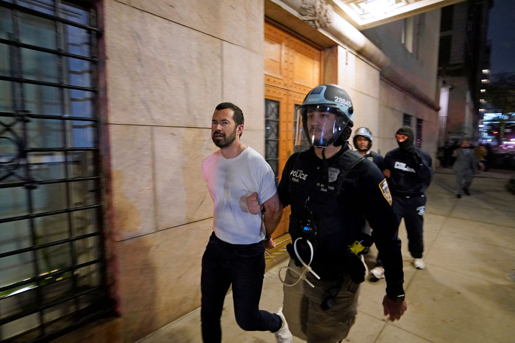 A NYPD officer arrests a student at Columbia University Tuesday night.