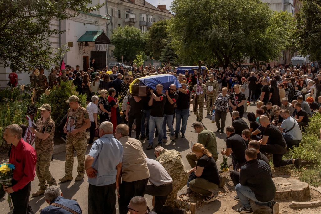 Men carry coffins during the funeral of six Ukrainian servicemen, who were killed after Ukraine launched its offensive at the Russian border region of Kursk.