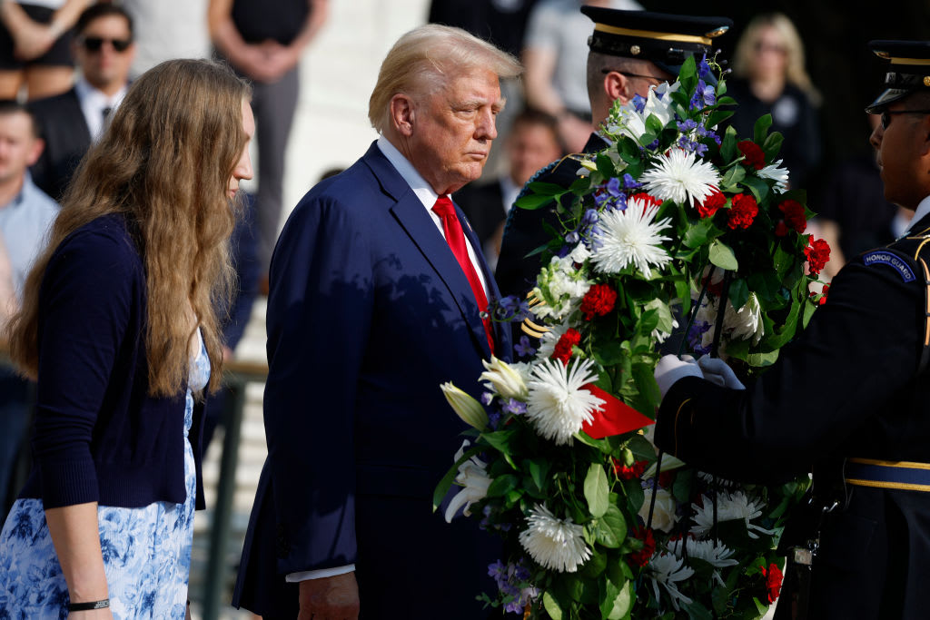 Donald Trump lays a wreath with a fallen soldier’s sister.