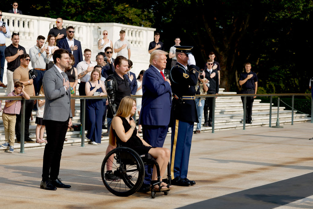 Donald Trump stands with his hand over his heart at Arlington National Cemetery.