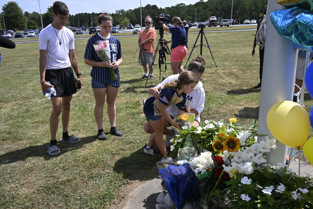 People gather to pay their respects a day after the mass shooting at Apalachee high school in Winder, Georgia.