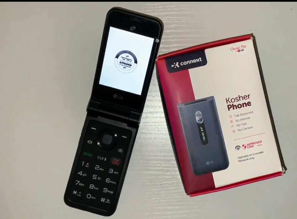 A cellphone sits next to its package